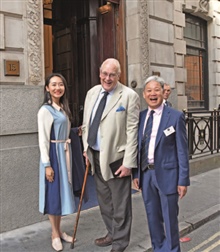 Ms Yuri, Michael Sefi LVO RDP FRPSL, former Keeper of the Royal Philatelic Collection, and Jack Zhang FRPSL look excited before stepping in. 